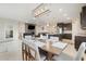 Open-concept dining area with stylish lighting, table, seating, with sightlines to kitchen and living areas at 13797 Wineberry Dr, Dade City, FL 33525