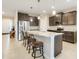 Kitchen with granite counters, stainless appliances, and island with breakfast bar and pendant lighting at 13797 Wineberry Dr, Dade City, FL 33525
