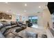 Spacious living room boasting tile flooring, modern furnishings, and sliding glass doors leading to a patio at 13797 Wineberry Dr, Dade City, FL 33525