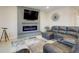 Comfortable living area with a gray fireplace, large TV, stylish sofa, and accent furniture at 13797 Wineberry Dr, Dade City, FL 33525