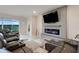 Living space features a plush sectional, a modern fireplace and large windows for lots of natural light at 13797 Wineberry Dr, Dade City, FL 33525