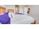 Comfortable main bedroom features wood furniture and plush bedding and an open doorway at 13797 Wineberry Dr, Dade City, FL 33525