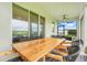Outdoor patio with dining table and fan at 13797 Wineberry Dr, Dade City, FL 33525