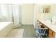 Bright bathroom featuring vanity with chair, glass enclosed walk-in shower, and soaking tub at 26620 Shoregrass Dr, Wesley Chapel, FL 33544
