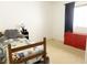 Bedroom featuring a twin bed with colorful quilt, a red dresser, and blue curtain at 26620 Shoregrass Dr, Wesley Chapel, FL 33544