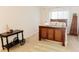 Bedroom featuring a full bed with side tables, a chest of drawers, and a small display table at 26620 Shoregrass Dr, Wesley Chapel, FL 33544