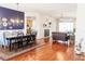 A combined dining and living room with hardwood floors, a blue accent wall, and modern decor at 26620 Shoregrass Dr, Wesley Chapel, FL 33544