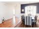 A dining room offers wood floors, a blue accent wall, natural light, and seating for six at 26620 Shoregrass Dr, Wesley Chapel, FL 33544