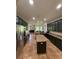 A large kitchen with dark wood cabinets, granite countertops, stainless steel appliances, and a tile floor at 26620 Shoregrass Dr, Wesley Chapel, FL 33544