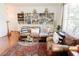 Beautiful living room features hardwood floors, a decorative rug, and built-in bookshelves at 26620 Shoregrass Dr, Wesley Chapel, FL 33544