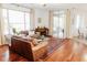 Spacious living area with hardwood floors, plush seating, sliding glass doors to patio, and piano at 26620 Shoregrass Dr, Wesley Chapel, FL 33544