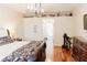 Spacious main bedroom with hardwood floors, ensuite bath, and a modern light fixture at 26620 Shoregrass Dr, Wesley Chapel, FL 33544