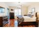 Primary bedroom features hardwood floors, natural light, TV, and access to the outdoors at 26620 Shoregrass Dr, Wesley Chapel, FL 33544