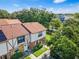 Aerial view of the charming townhome community featuring lush greenery and well-maintained landscapes at 3401 Sunrise Villas S Ct, Tampa, FL 33614