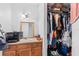 Bathroom features a vanity with a sink and a gold-framed mirror and a closet filled with hanging clothes at 3401 Sunrise Villas S Ct, Tampa, FL 33614
