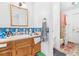 The bathroom has tile accents and a vanity that complements the shower area at 3401 Sunrise Villas S Ct, Tampa, FL 33614