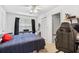 Bright bedroom featuring ample natural light, neutral walls, and closet space at 3401 Sunrise Villas S Ct, Tampa, FL 33614