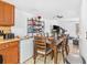Dining room with a wood table and chairs, adjacent to the kitchen and living area at 3401 Sunrise Villas S Ct, Tampa, FL 33614