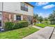Charming townhome overlooking a pond, featuring brick accents and well-maintained landscaping at 3401 Sunrise Villas S Ct, Tampa, FL 33614