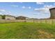 Large backyard with lush green grass and a sturdy white fence at 2139 Stellar Brilliance Way, Lutz, FL 33558
