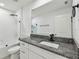 Modern bathroom featuring granite counters, a stylish shower, and contemporary fixtures at 2139 Stellar Brilliance Way, Lutz, FL 33558