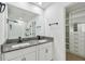 Bathroom with double granite vanity, view to walk-in closet, and sleek glass shower at 2139 Stellar Brilliance Way, Lutz, FL 33558