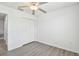 Bright bedroom with a ceiling fan, closet, and stylish flooring at 2139 Stellar Brilliance Way, Lutz, FL 33558