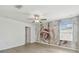 Bright bedroom with light-colored floors, decorative accent wall, ceiling fan, and a window at 2139 Stellar Brilliance Way, Lutz, FL 33558