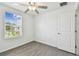 Well-lit bedroom with a ceiling fan and a large window offering a pleasant view at 2139 Stellar Brilliance Way, Lutz, FL 33558