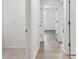 Bright hallway featuring wood floors and white walls leading to various rooms in the home at 2139 Stellar Brilliance Way, Lutz, FL 33558