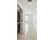 Bright hallway with tile flooring and a view into a powder room with decorative wallpaper at 2139 Stellar Brilliance Way, Lutz, FL 33558