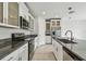 Modern kitchen features white cabinets, granite countertops, stainless steel appliances and tile flooring at 2139 Stellar Brilliance Way, Lutz, FL 33558