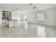 Open living room area with tile floors, ceiling fan, and view of kitchen island at 2139 Stellar Brilliance Way, Lutz, FL 33558