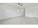 Bright and spacious living room with tile floors, elegant wall trim, and a ceiling fan at 2139 Stellar Brilliance Way, Lutz, FL 33558