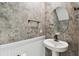 Elegant powder room features decorative wallpaper, wainscoting, and a modern sink at 2139 Stellar Brilliance Way, Lutz, FL 33558