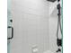 Modern bathroom shower featuring a square shower head and a handheld sprayer against bright white tiled walls at 2139 Stellar Brilliance Way, Lutz, FL 33558