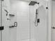 Modern shower featuring white tiling, sleek shower head, and glass enclosure at 2139 Stellar Brilliance Way, Lutz, FL 33558