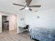 Bedroom featuring ceiling fan, light gray floor and adjacent laundry room at 3723 Toulouse Ct, Punta Gorda, FL 33950