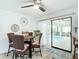 Cozy dining area with a table set for four, adjacent to a sliding glass door with a pool view at 3723 Toulouse Ct, Punta Gorda, FL 33950
