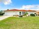 Charming single-story home featuring a well-manicured lawn and a distinctive red tile roof at 3723 Toulouse Ct, Punta Gorda, FL 33950