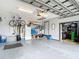 Spacious garage with ample storage, featuring a bicycle lift and access door to another room at 3723 Toulouse Ct, Punta Gorda, FL 33950