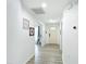 Bright hallway with clean white walls, featuring modern decor and leading to the main entry door at 3723 Toulouse Ct, Punta Gorda, FL 33950