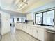 Bright and airy kitchen boasts white cabinets, modern appliances, and a large sink with updated fixtures at 3723 Toulouse Ct, Punta Gorda, FL 33950