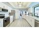 This kitchen includes bright white cabinetry, stainless appliances, updated countertops, and an open floor plan at 3723 Toulouse Ct, Punta Gorda, FL 33950