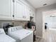 Laundry room featuring washer, dryer, water heater and utility sink at 3723 Toulouse Ct, Punta Gorda, FL 33950