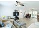 Spacious living room with contemporary furnishings, ceiling fan, and seamless access to the dining area at 3723 Toulouse Ct, Punta Gorda, FL 33950