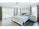 Spacious main bedroom with neutral decor, ample natural light, ceiling fan, and view to outdoor pool at 3723 Toulouse Ct, Punta Gorda, FL 33950
