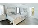 This bedroom features an ensuite bathroom, updated decor, large bed, ceiling fan, and ample natural light at 3723 Toulouse Ct, Punta Gorda, FL 33950
