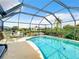Lovely enclosed pool area with canal views, complete with seating and lush landscaping at 3723 Toulouse Ct, Punta Gorda, FL 33950