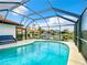 Enclosed pool area showcasing a serene waterfront view and comfortable outdoor seating at 3723 Toulouse Ct, Punta Gorda, FL 33950
